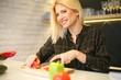 © liderina - Smiling woman preparing vegetable salad.