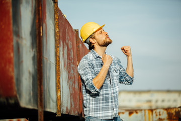 strong man, worker on site with helmet on head