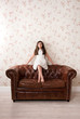 © photology1971 - Portrait of a pretty little girl on a leather sofa
