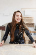 © Rithor - Portrait of a smiling woman with sawdust on the hair. girl works in a carpenters workshop, female small business