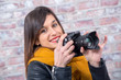 young brunette woman with a photographic camera