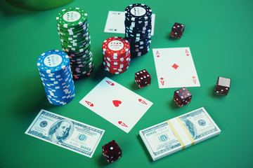 3D illustration playing chips, cards and money for casino game on green table. Real or Online casino concept.