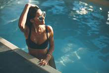 Young Slim Woman Relaxing By Swimming Pool