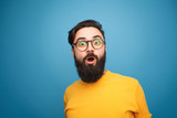 Fototapeta  - Super excited bearded hipster looking at camera
