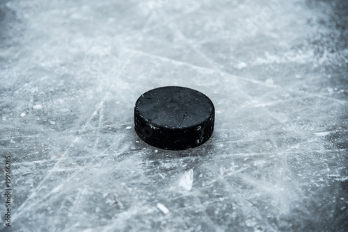 Fototapeta na szkło hockey puck lies on the snow close-up
