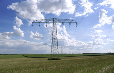 Power Lines: A 110 KV and a 220 KV high-voltage power line crossing over a stubblefield in Eastern Thuringia