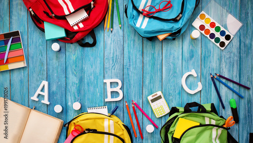 Colourful Children Schoolbags On Wooden Floor Backpacks With