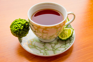 Hot tea with bergamot on wooden table in the cold. Winter.