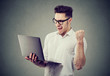 © Feodora - Excited man with laptop computer celebrating success