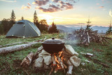 Fototapeta  - Tourist camp with fire, tent and firewood