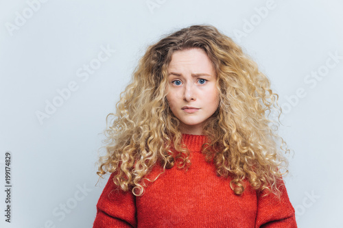 Photo Of Displeased Unhappy Young Woman With Curly Bushy Blonde