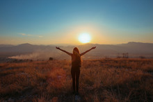 Sunset Mountain. Tourist Free Happy  Woman Outstretched Arms With Backpack Enjoying Life In Wheat Field. Hiker Cheering Elated And Blissful With Arms Raised.