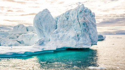 Wall Mural - Iceberg aerial footage - giant icebergs in Disko Bay on greenland floating in Ilulissat icefjord from melting glacier Sermeq Kujalleq Glacier, aka Jakobhavns Glacier. Global warming and climate change