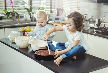 Wall Mural - Cheerful siblings making a dessert