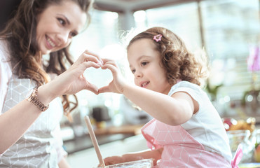 Kitchen shot - mother and daughter making a cake