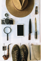 Wall Mural - adventure planning flat lay. travel vintage gear on map. sartphone, mobile in center of frame. explo