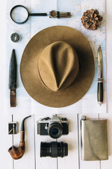 Wall Mural - adventure planning flat lay. travel vintage gear on map. including film camera, hat, knife, loupe, c