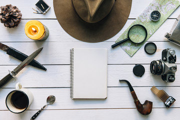 Wall Mural - adventure planning flat lay. travel vintage gear on white wooden table. including boots, smoking pip