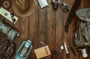 Wall Mural - hiking gear frame including machete, knife, clothes, boots, lantern, camera, hat, map, compass. wand