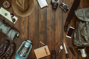 Wall Mural - hiking gear frame including machete, knife, clothes, boots, lantern, camera, hat, map, compass, mobi