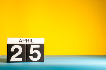 Sticker - April 25th. Day 25 of april month, calendar on table with yellow background. Spring time, empty space for text