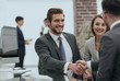 © ASDF - happy man introducing businesswoman to business partners