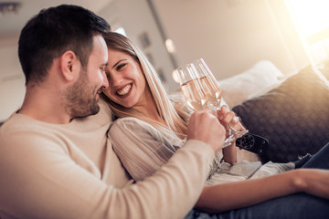 Poster - Young couple toasting wine glasses