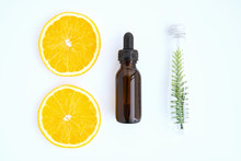 Top View, Bottle Of Natural Oil And Orange, Blank Label Package For Mockup On White Background. The Concept Of Natural Beauty Products.