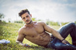 © theartofphoto - Good looking, shirtless fit male model relaxing lying on the grass, shot from above