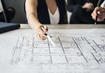 Woman pointing at building plan