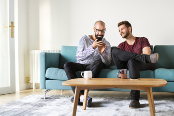 Sticker - Two men chilling on a couch