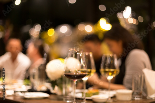 Fotomural Group of friends having a dinner and wine in blurred conceptaul