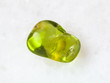 tumbled olivine gem stone on white