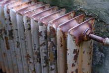 Old Obsolete Rusty Radiator. The Problem Of Winter House Heating. Cold, Poor Heating In Old Housing.
