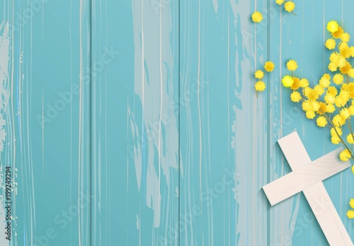 Fotografía White cross and mimosa banch on blue rustic wooden background