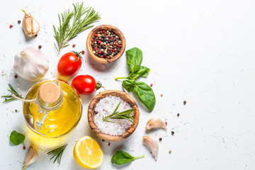 Sticker - Spices, herbs and olive oil over white stone table.