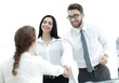 © ASDF - young business woman shaking hands with a colleague