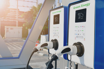 electric vehicle charging (Ev) station with plug of power cable supply for Ev car. payment NFC. Flare light effect.