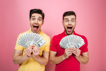 Canvas Print - Portrait of a happy gay male couple holding money