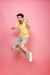 Poster - Full length portrait of an excited young man jumping