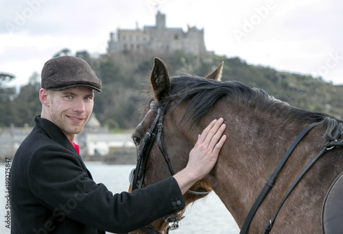 Handsome Male Horse Rider On Horseback Wearing Flat Cap White
