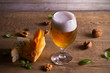 Beer and cheese. Beer glass on wooden table. Ale and appetizer snack. horizontal