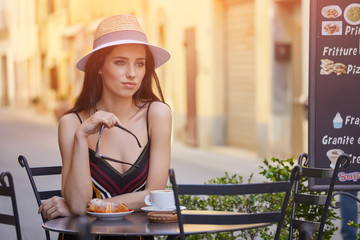 Canvas Print - Stylish sexy lady waiting for someone at restaurant. rich slim brunette girl with long glossy hair at vacation resting at bar.