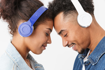 Wall Mural - Side view of Smiling lovely african couple in denim shirts