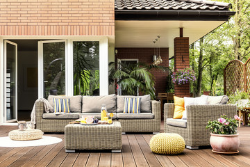 Wall Mural - Yellow pouf on wooden patio