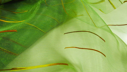 Green abstract background made of light fabric.