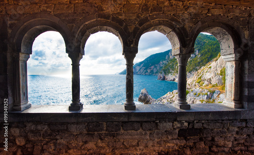 magical sea view through the castle and gothic Church of St. Peter arches in ...