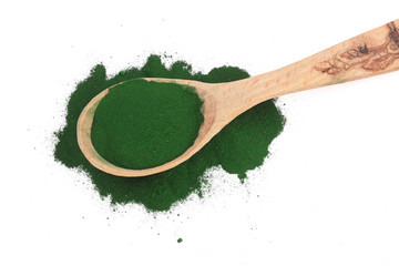 Spirulina algae powder in wooden spoon isolated on white background. Top view