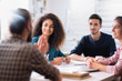 © jackfrog - At office. A young man leads a multiethnic working group