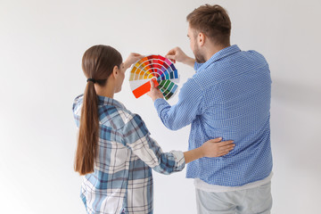 Sticker - Young couple with color palette on white background